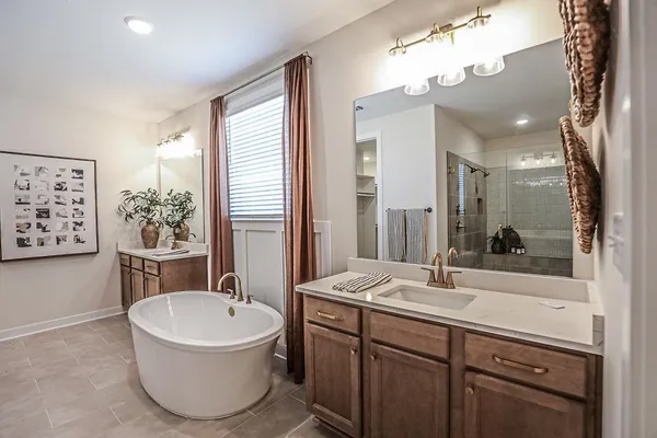 a bathroom with a sink a bathtub and a mirror