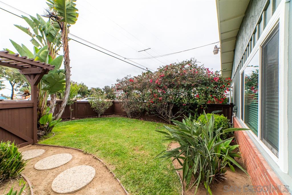 1095 Regal Road Encinitas, CA 92024 - Photo 5 of 21 a backyard of a house with a fountain plants and large tree