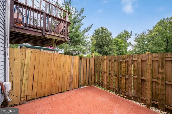 a view of a backyard with wooden fence