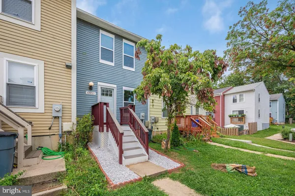 a view of a house with a yard and a slide