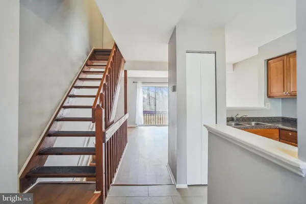 a view of a kitchen with wooden floor and stairs