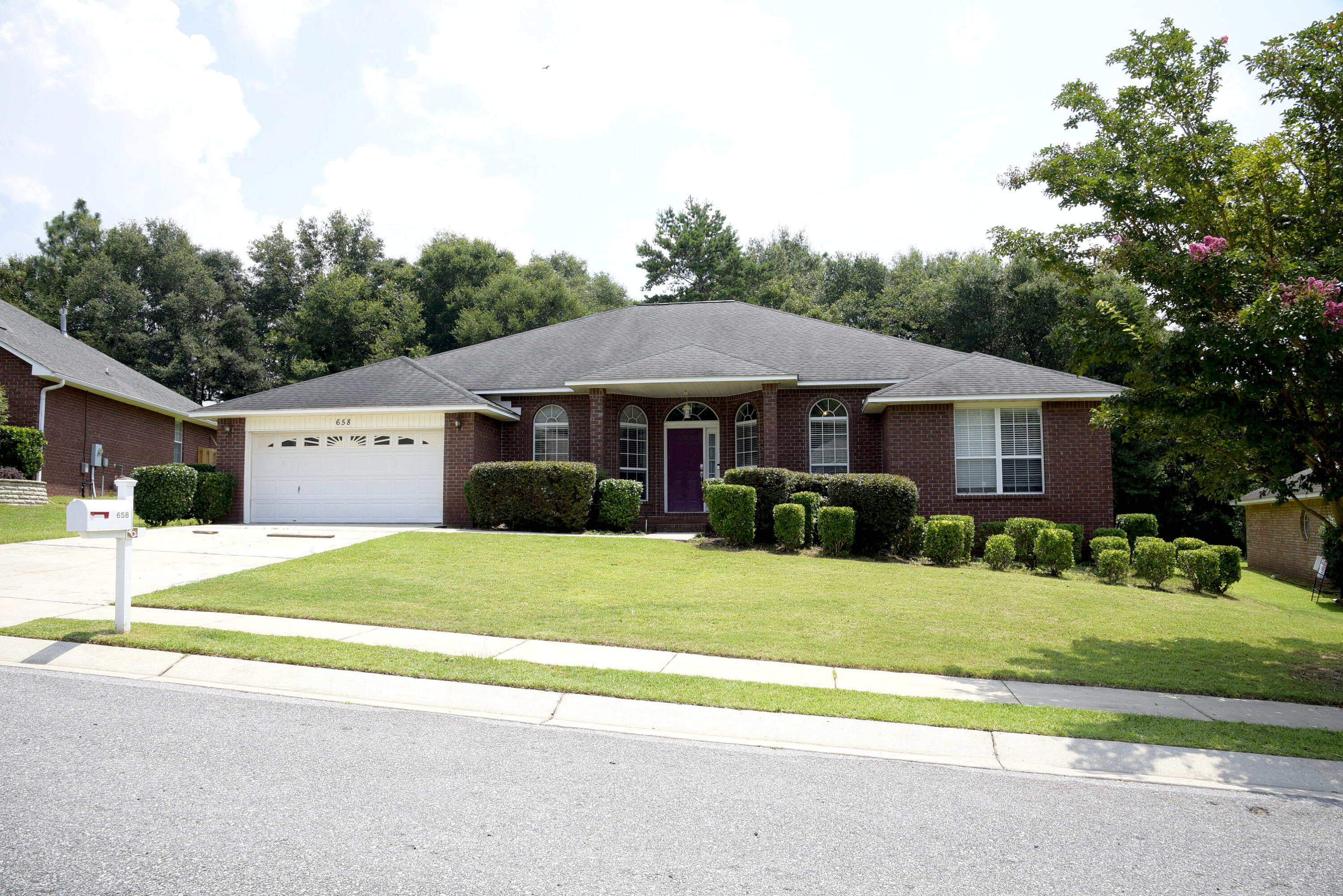 658 Territory Lane Crestview, FL 32536 - Photo 1 of 40 a view of a house with a yard and large trees
