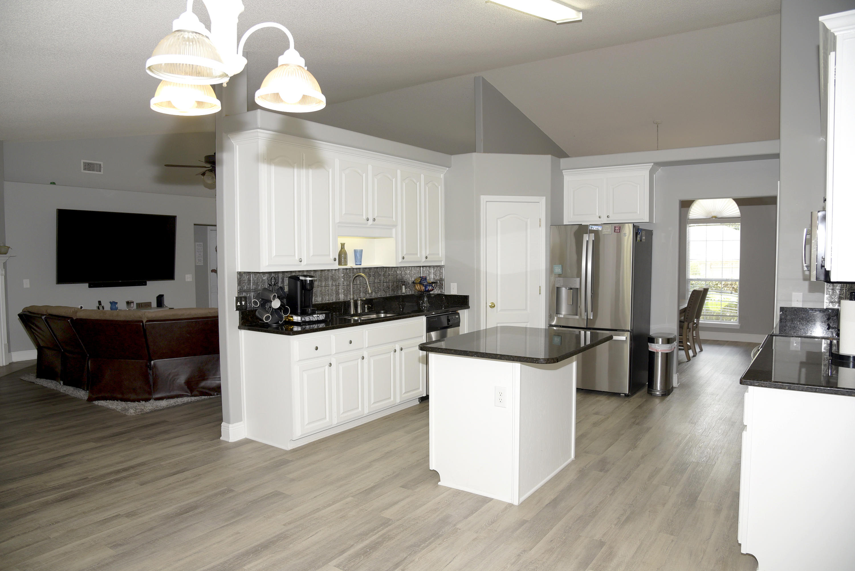 658 Territory Lane Crestview, FL 32536 - Photo 2 of 40 a kitchen with a refrigerator and a stove top oven