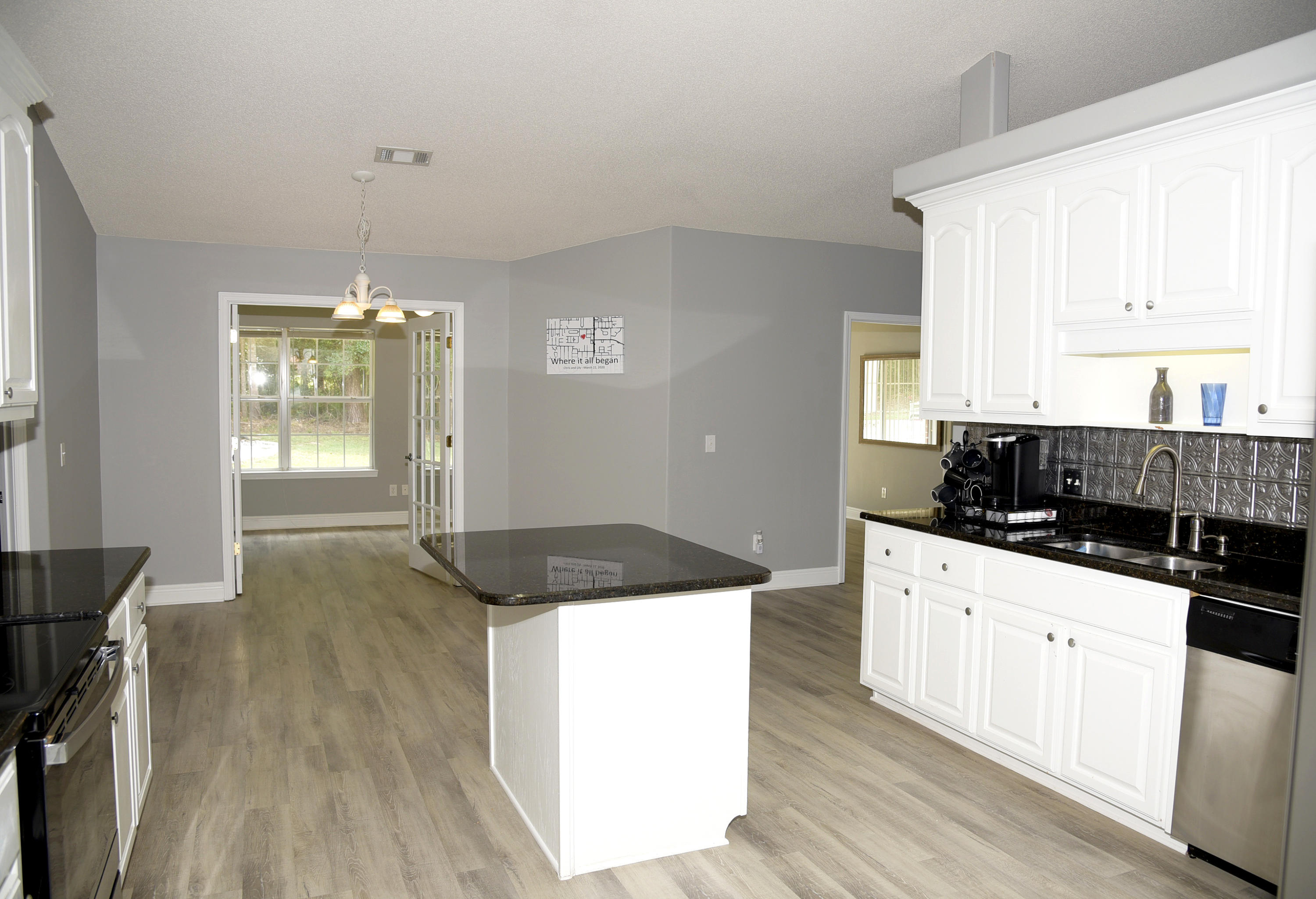 658 Territory Lane Crestview, FL 32536 - Photo 19 of 40 a kitchen with granite countertop a sink a counter top space and cabinets