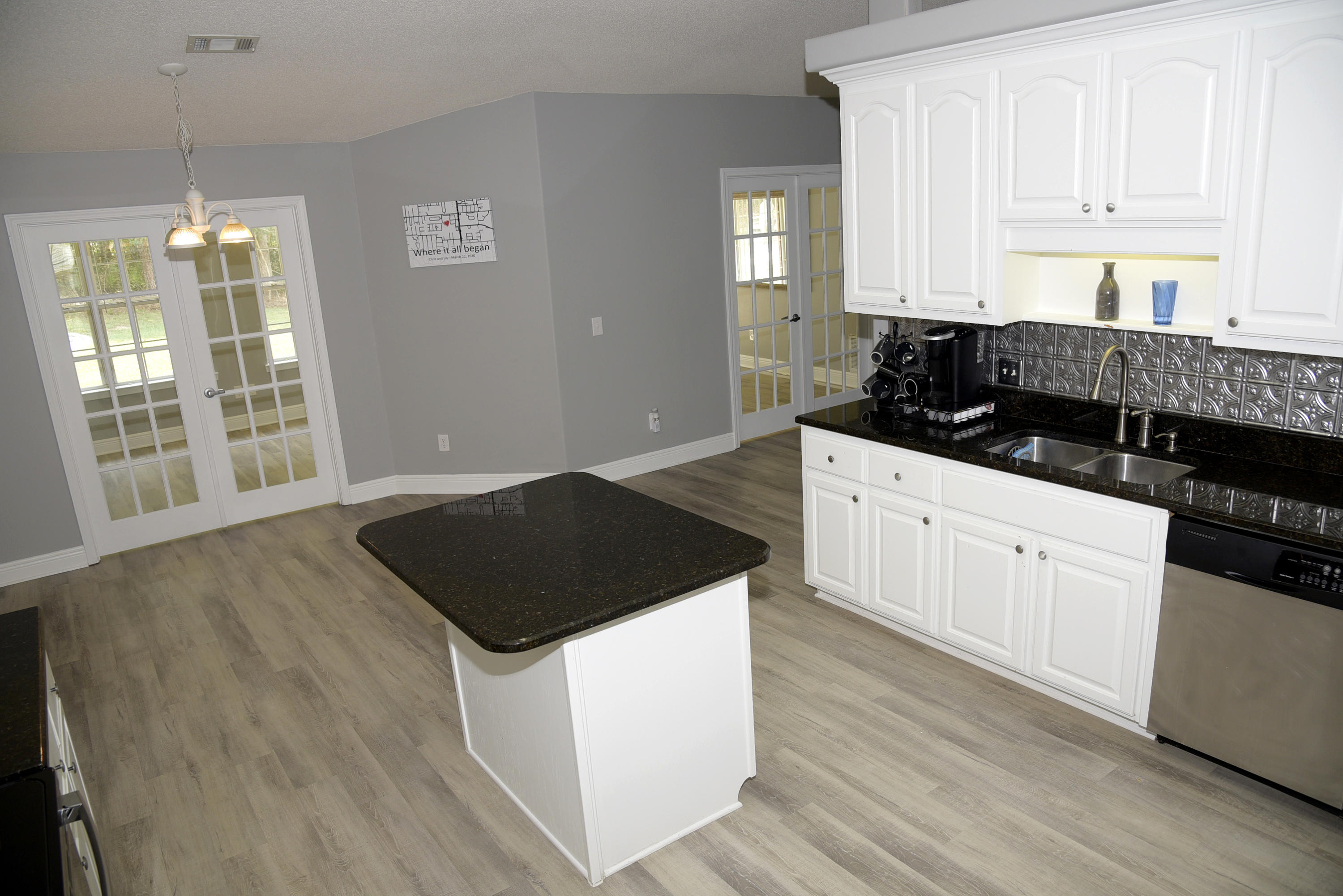 658 Territory Lane Crestview, FL 32536 - Photo 3 of 40 a kitchen with granite countertop white cabinets and window