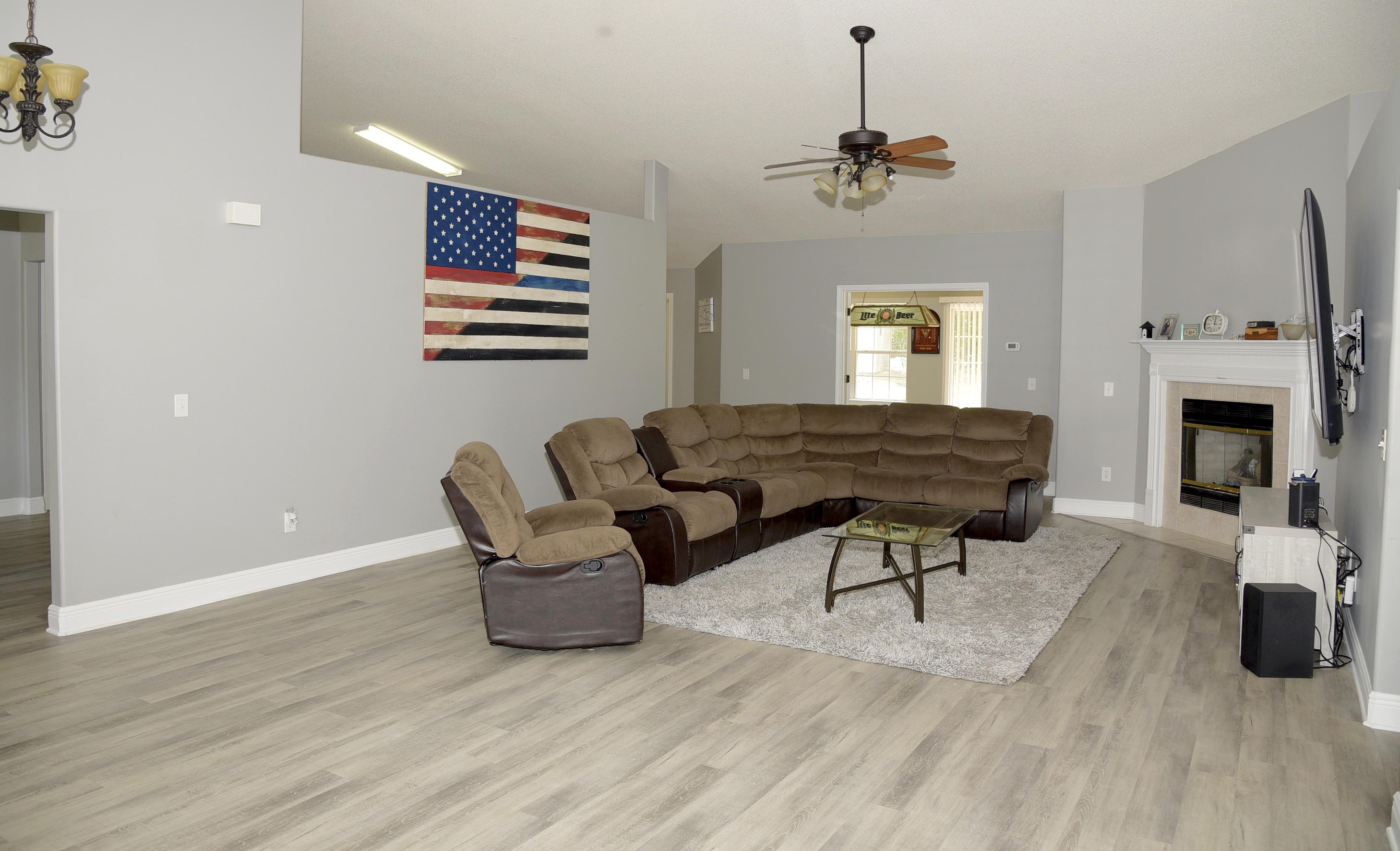 658 Territory Lane Crestview, FL 32536 - Photo 21 of 40 a living room with furniture a fireplace and a flat screen tv