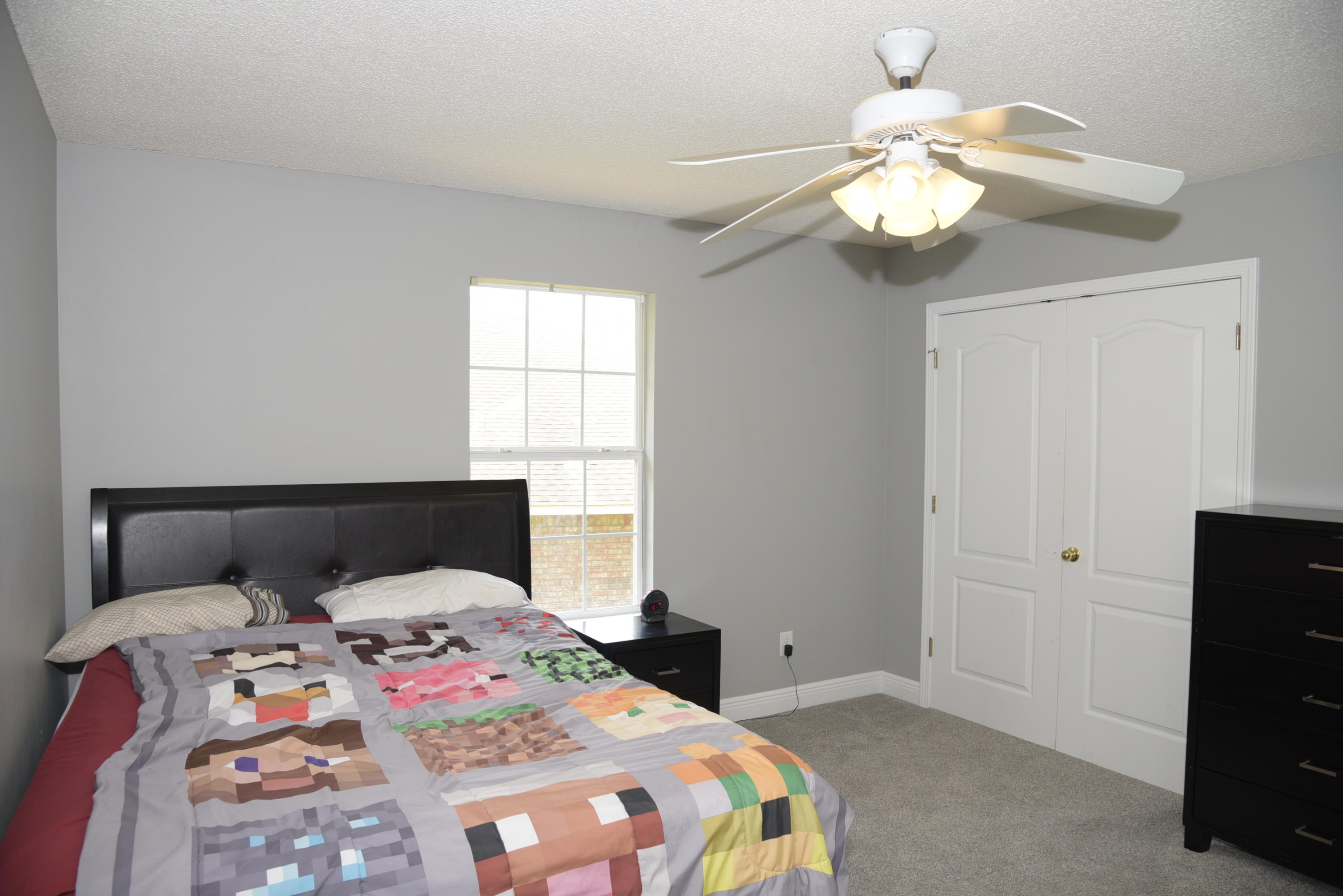 658 Territory Lane Crestview, FL 32536 - Photo 29 of 40 a bedroom with a bed and a chandelier