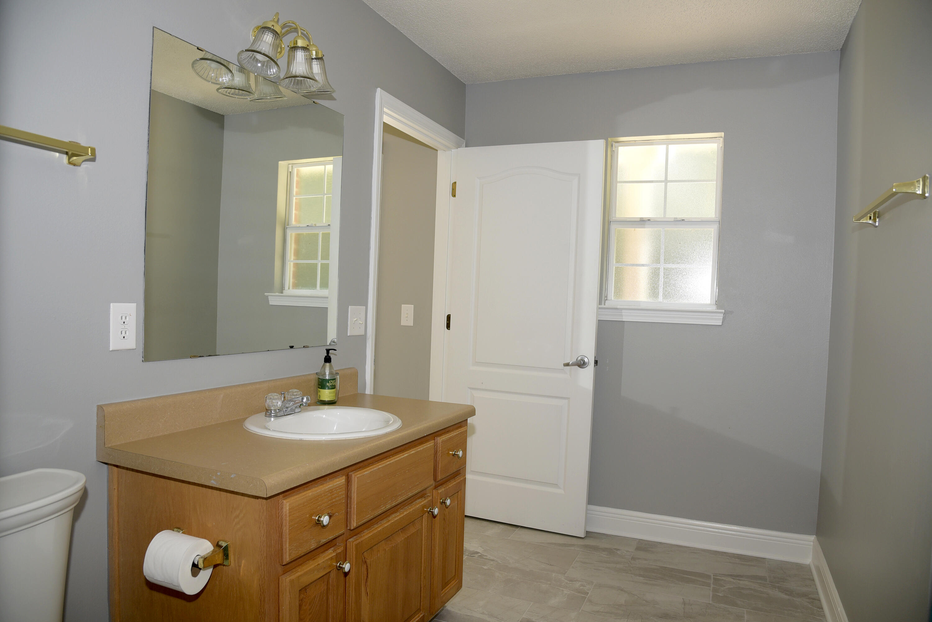 658 Territory Lane Crestview, FL 32536 - Photo 32 of 40 a bathroom with a sink vanity and a mirror