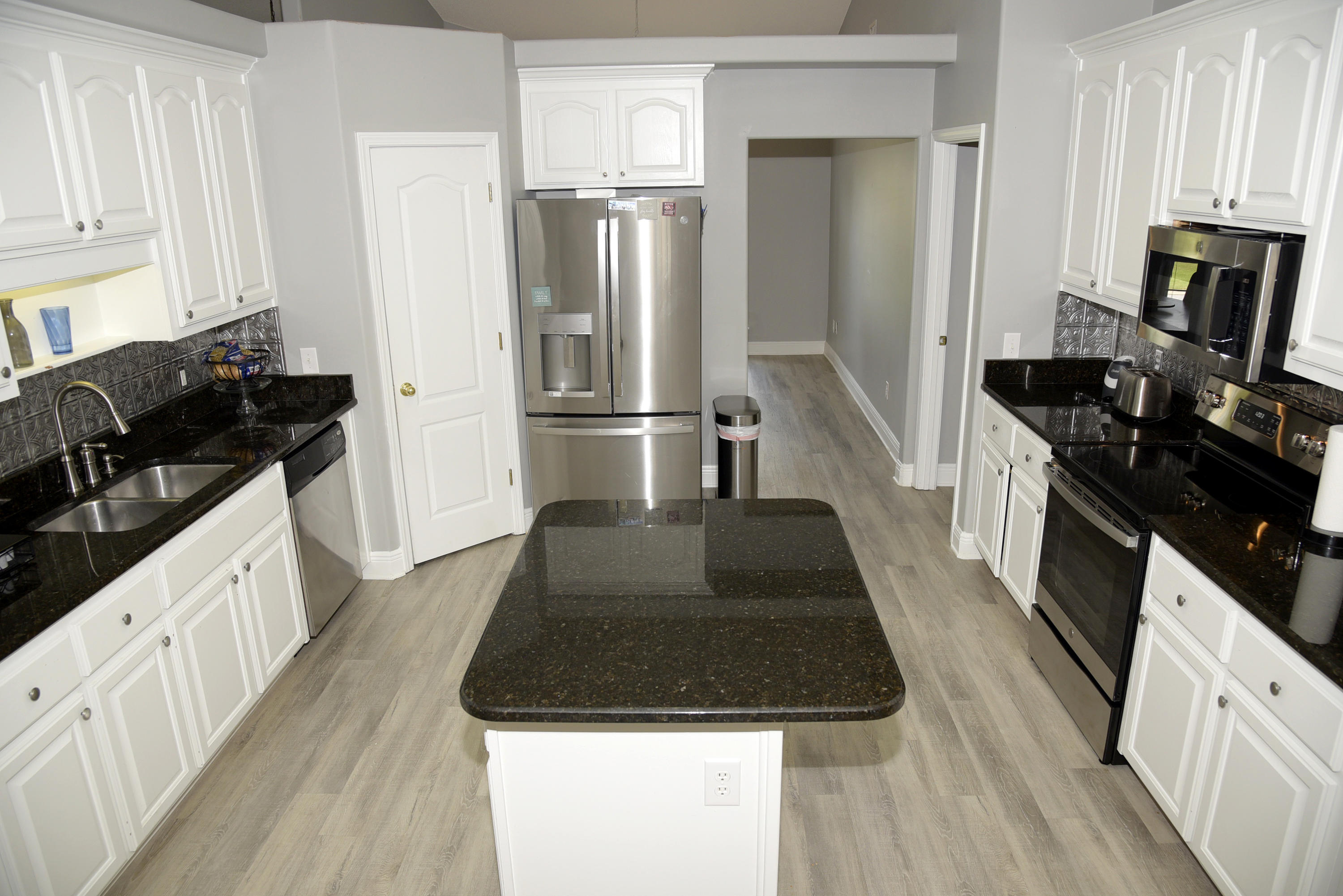 658 Territory Lane Crestview, FL 32536 - Photo 5 of 40 a kitchen with a sink stove and refrigerator