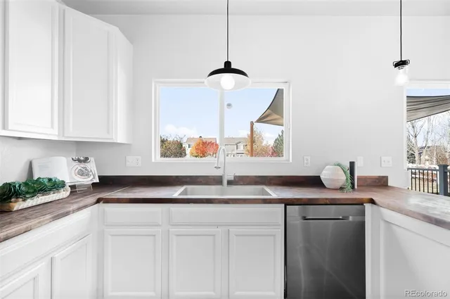 a kitchen with granite countertop a sink and a window