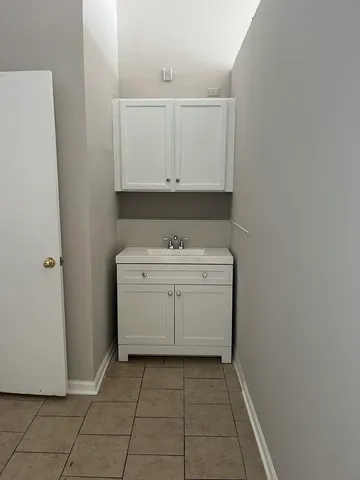 a bathroom with a sink toilet and a mirror