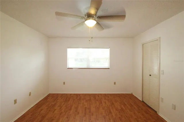 wooden floor in an empty room with a window