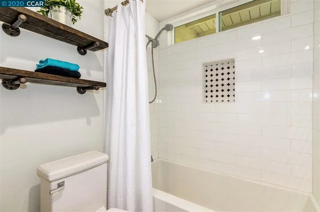 a bathroom with a shower and a toilet