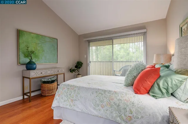 a bedroom with a bed and a potted plant