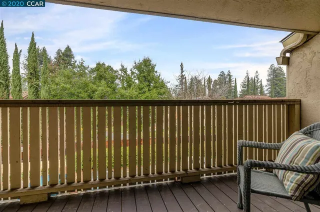 a view of a balcony with wooden floor and outdoor space