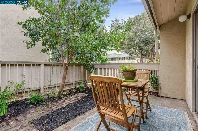 a view of a chairs and table in backyard