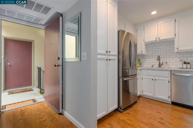 a kitchen with cabinets and stainless steel appliances