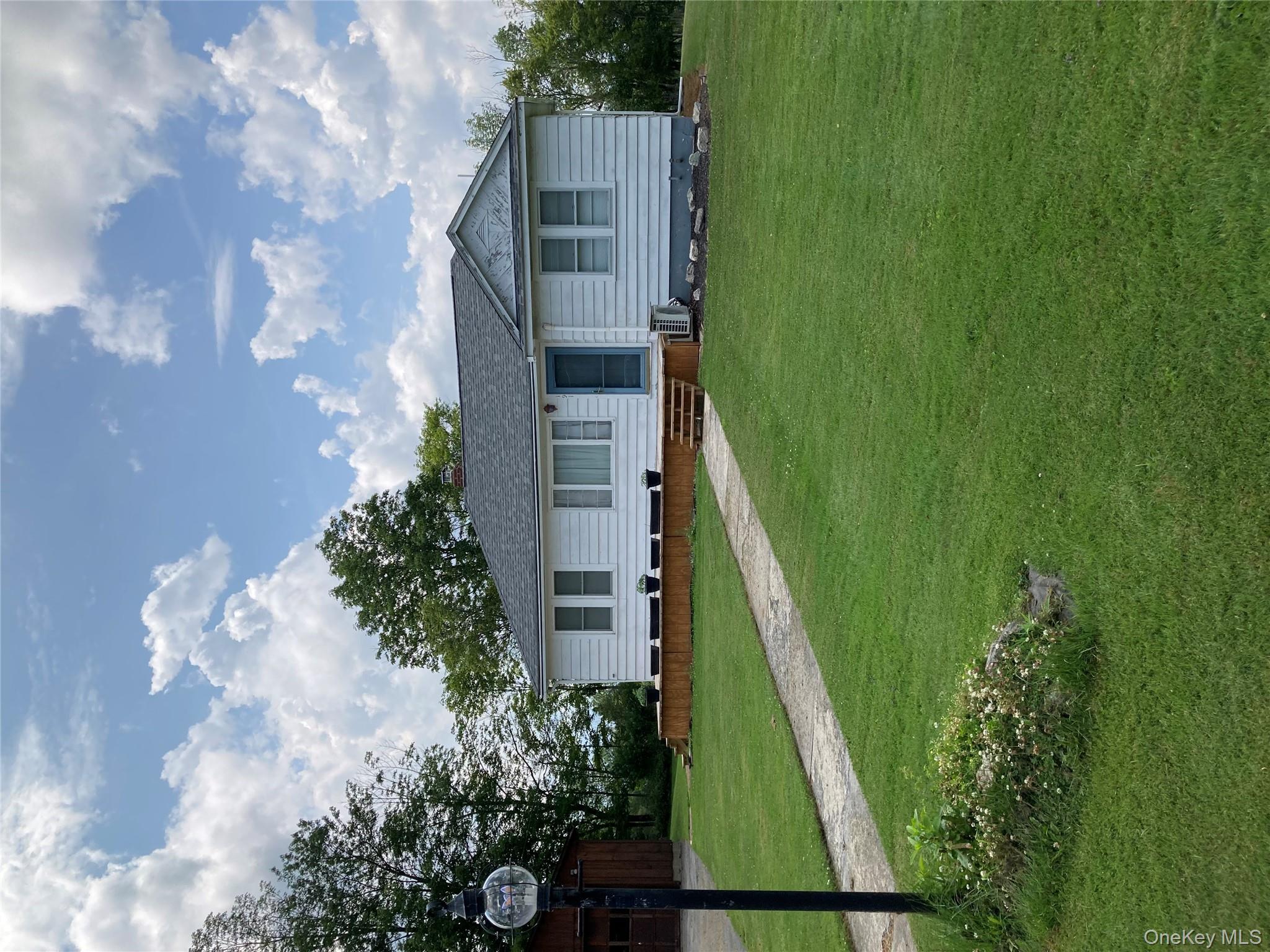 a view of house with a big yard