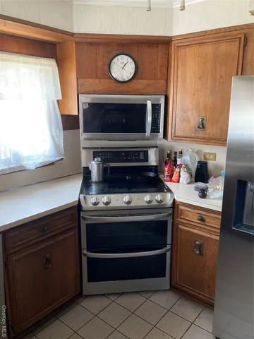a stove top oven sitting inside of a kitchen