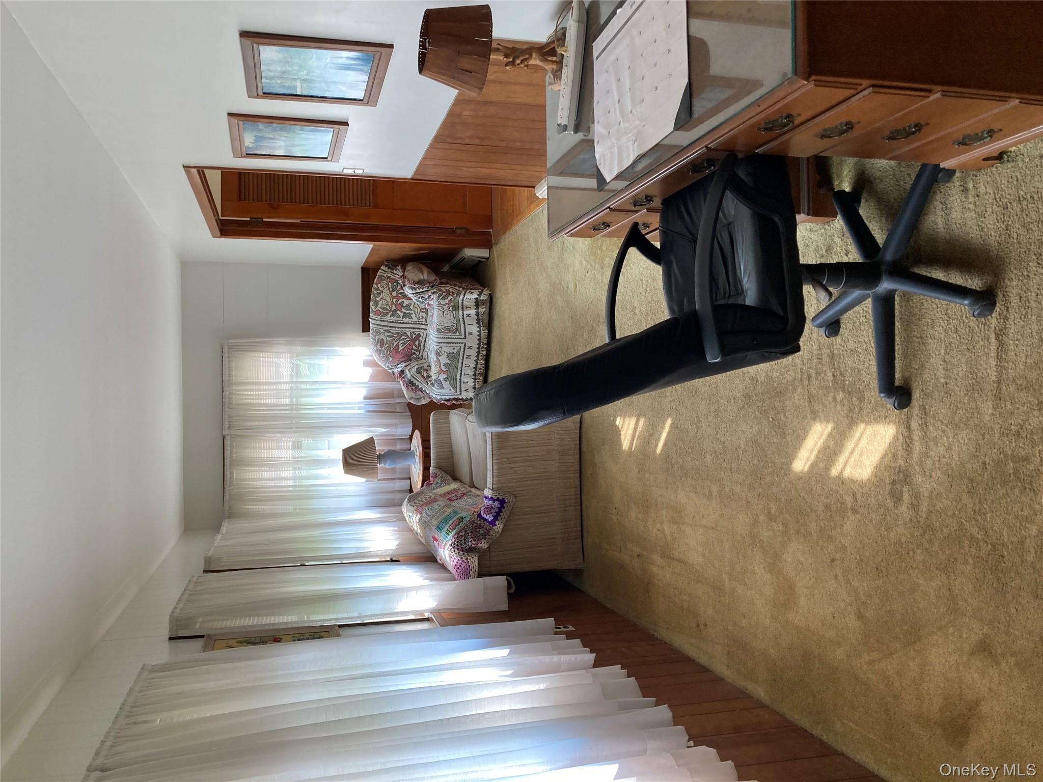 191 Rose Road Woodbourne, NY 12788 - Photo 31 of 32 a living room with furniture and a chandelier