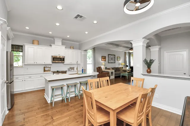 a kitchen with stainless steel appliances kitchen island granite countertop a sink stove and refrigerator