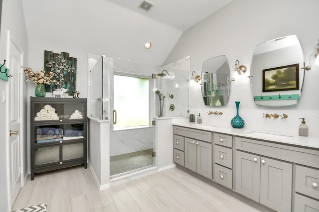 a spacious bathroom with a granite countertop sink mirror and cabinets