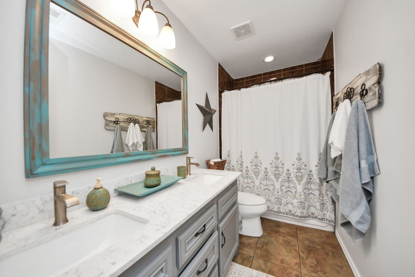 5360 Muske Lane Pattison, TX 77423 - Photo 29 of 44 a bathroom with a granite countertop sink a toilet a mirror and shower