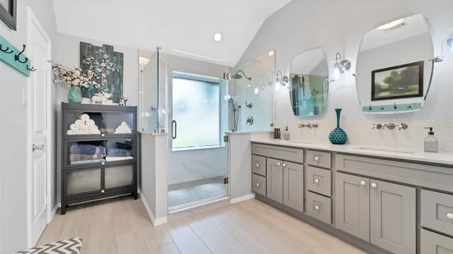 a spacious bathroom with a double vanity sink and a mirror