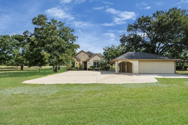 a view of a porch with furniture and a yard