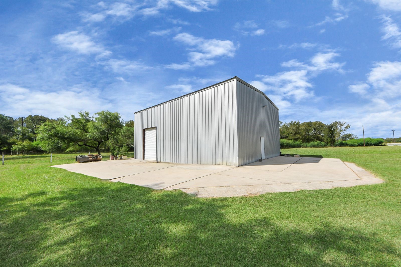 5360 Muske Lane Pattison, TX 77423 - Photo 5 of 44 a backyard of a house with plants and large trees
