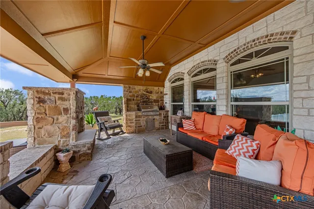 a outdoor living space with patio furniture and a fireplace