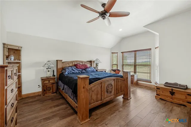 a view of house with garden and tall tress