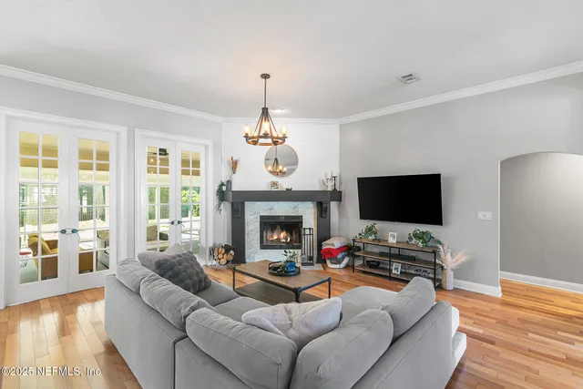 a living room with furniture a fireplace and a flat screen tv