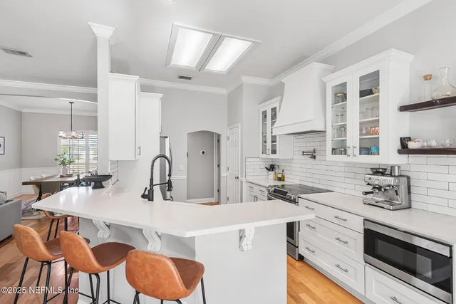 a kitchen with stainless steel appliances kitchen island granite countertop a sink and cabinets