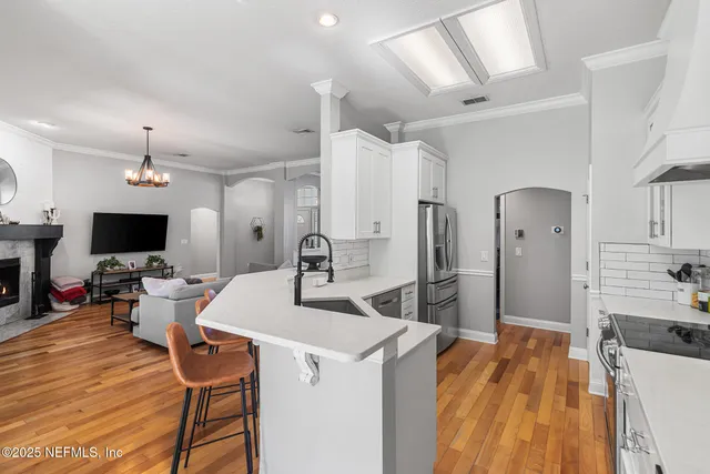 a large kitchen with a table and chairs in it