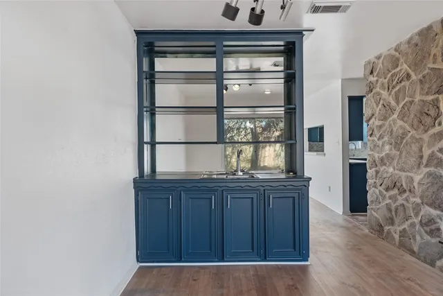 a living room with a fireplace and wooden floor