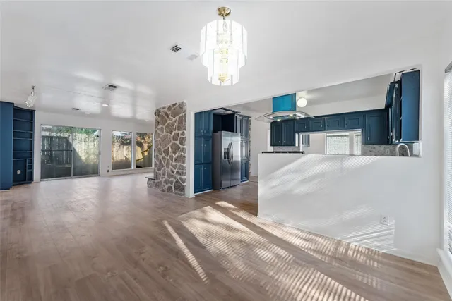 a kitchen with granite countertop a sink stove and cabinets