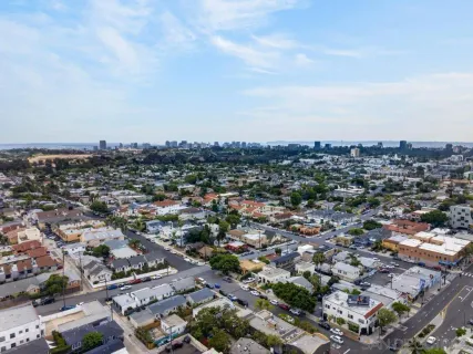 an aerial view of residential houses with outdoor space and parking