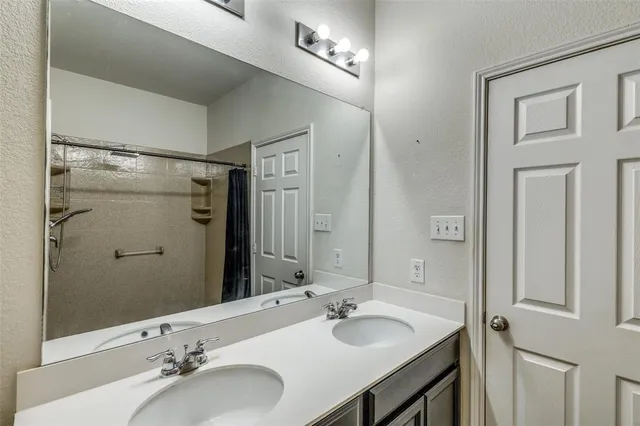 a bathroom with a sink double vanity and a mirror