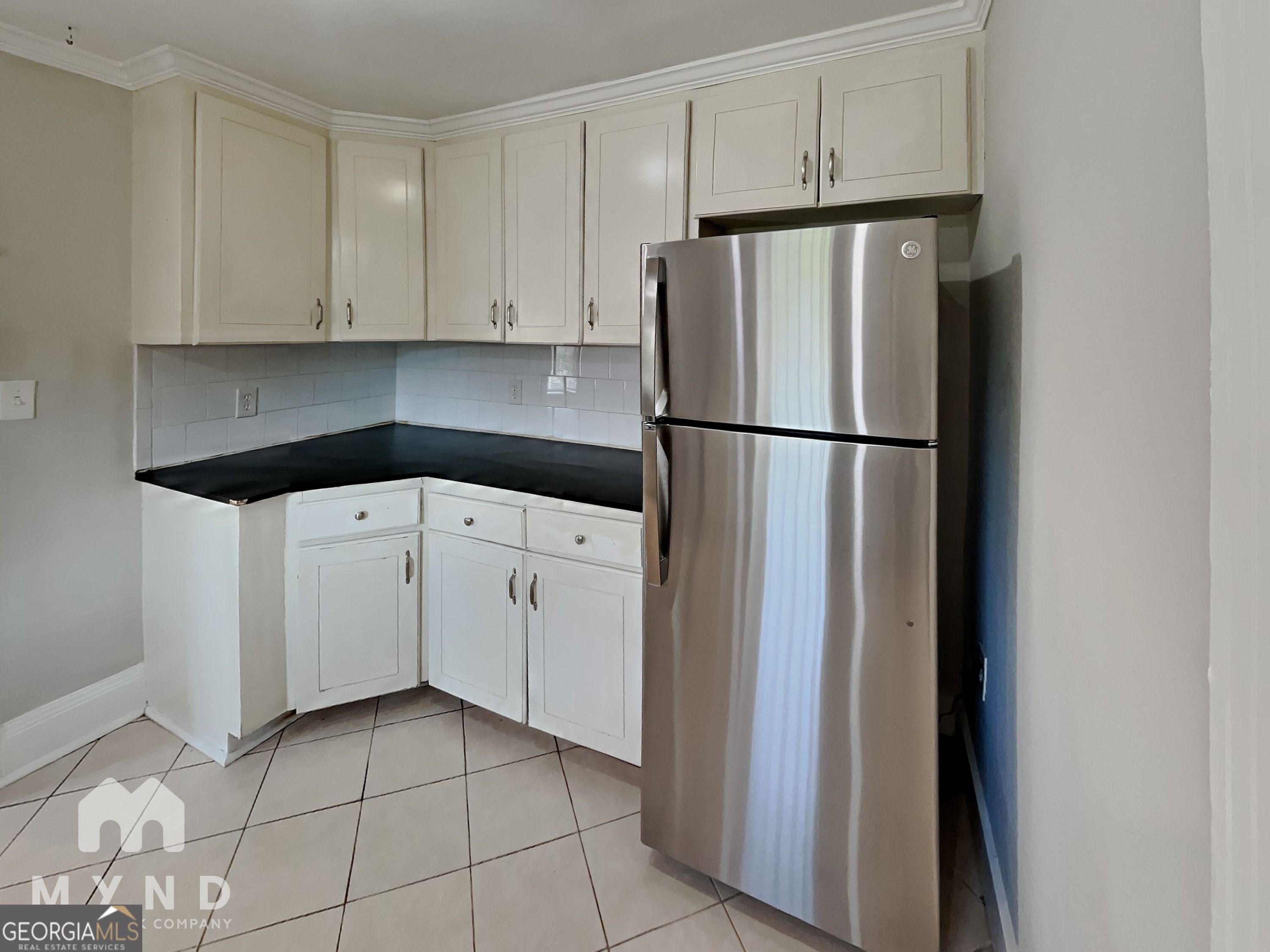 1337 South Hairston Road Stone Mountain, GA 30088 - Photo 3 of 17 a white refrigerator freezer sitting in a kitchen