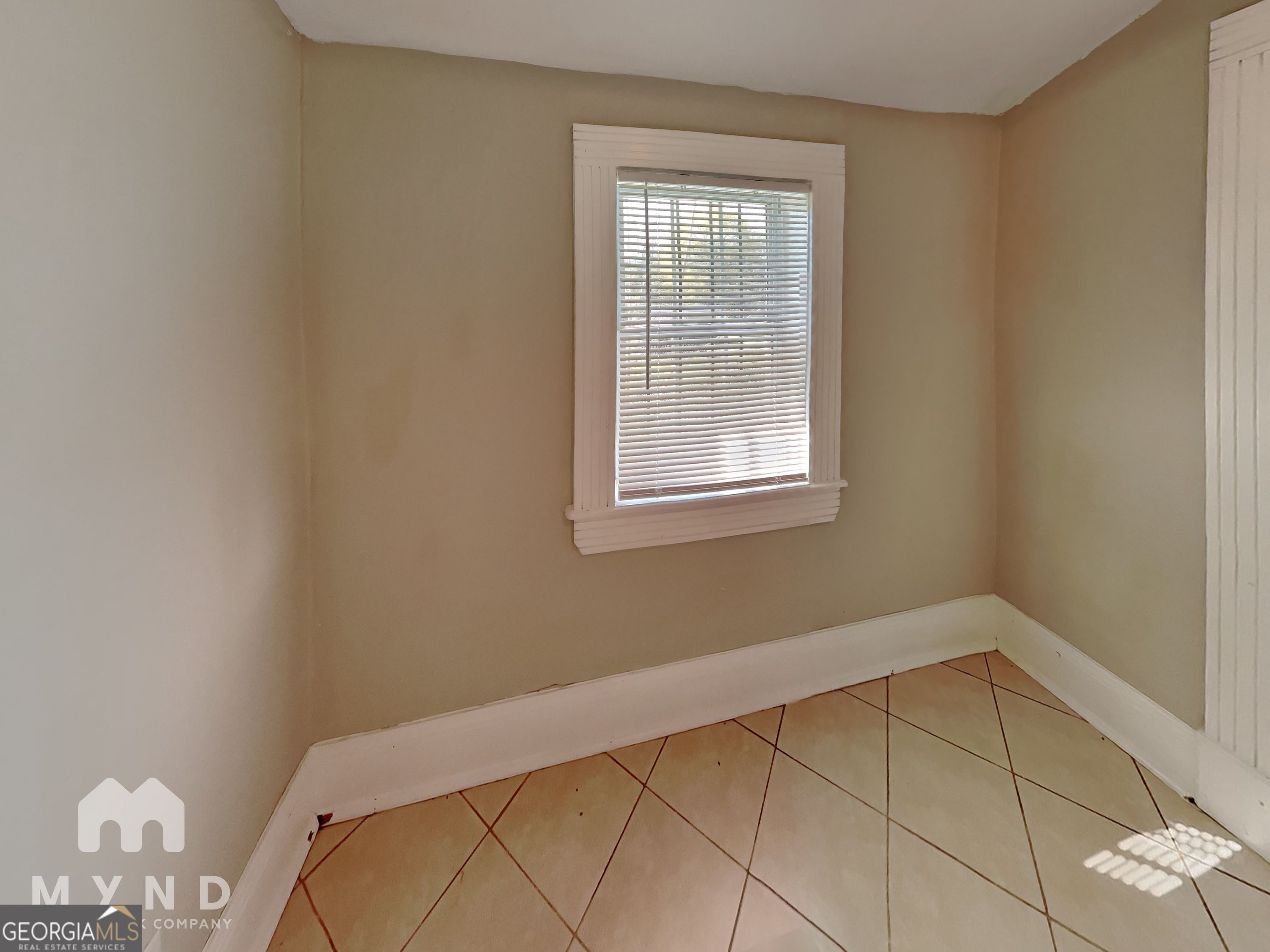 1337 South Hairston Road Stone Mountain, GA 30088 - Photo 8 of 17 a view of a room with rack on the wall and a window