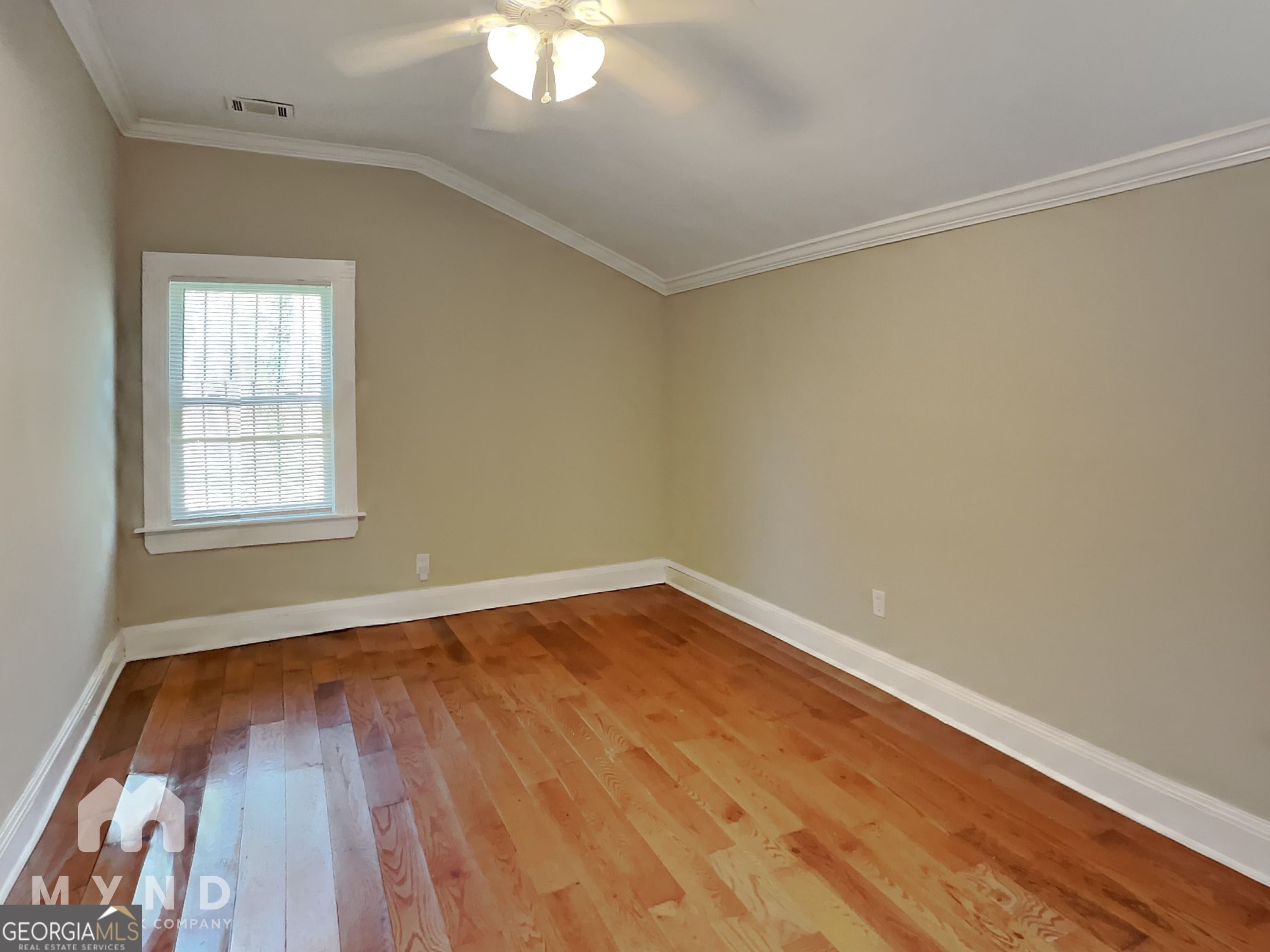 1337 South Hairston Road Stone Mountain, GA 30088 - Photo 10 of 17 an empty room with wooden floor and windows