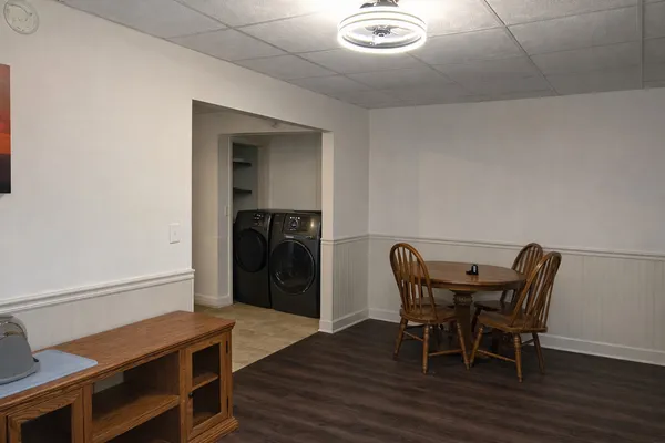 a view of a dining room with furniture and wooden floor
