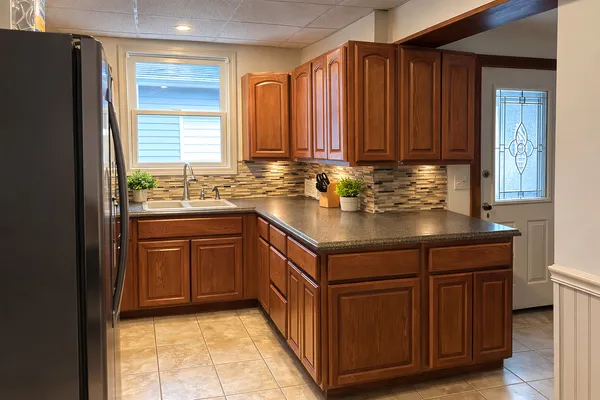 a kitchen with a sink and a refrigerator