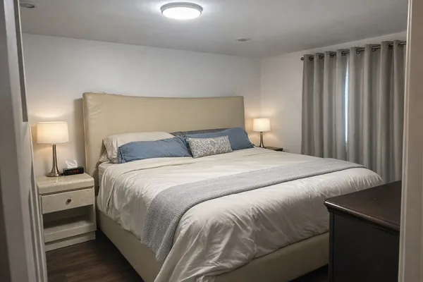 a bedroom with a bed and a lamp