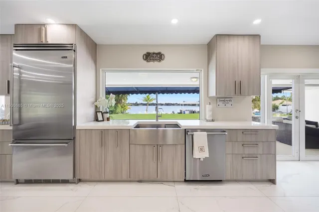 a kitchen with cabinets and chairs