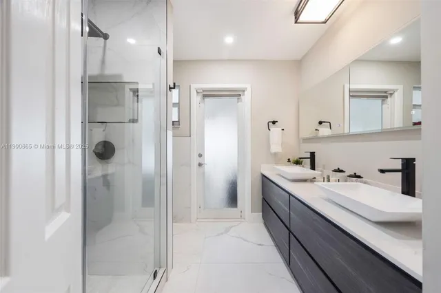 a bathroom with a sink vanity and mirror