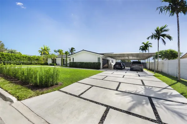 a front view of a house with a garden