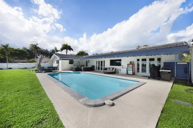 a view of a backyard with plants and palm tree