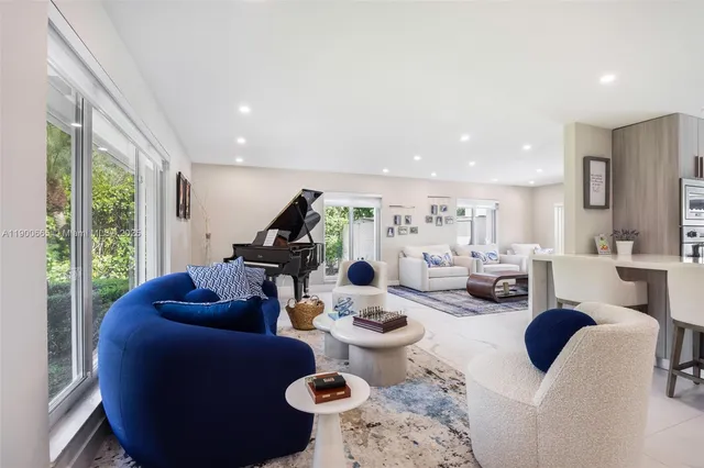 a living room with furniture kitchen and a kitchen view